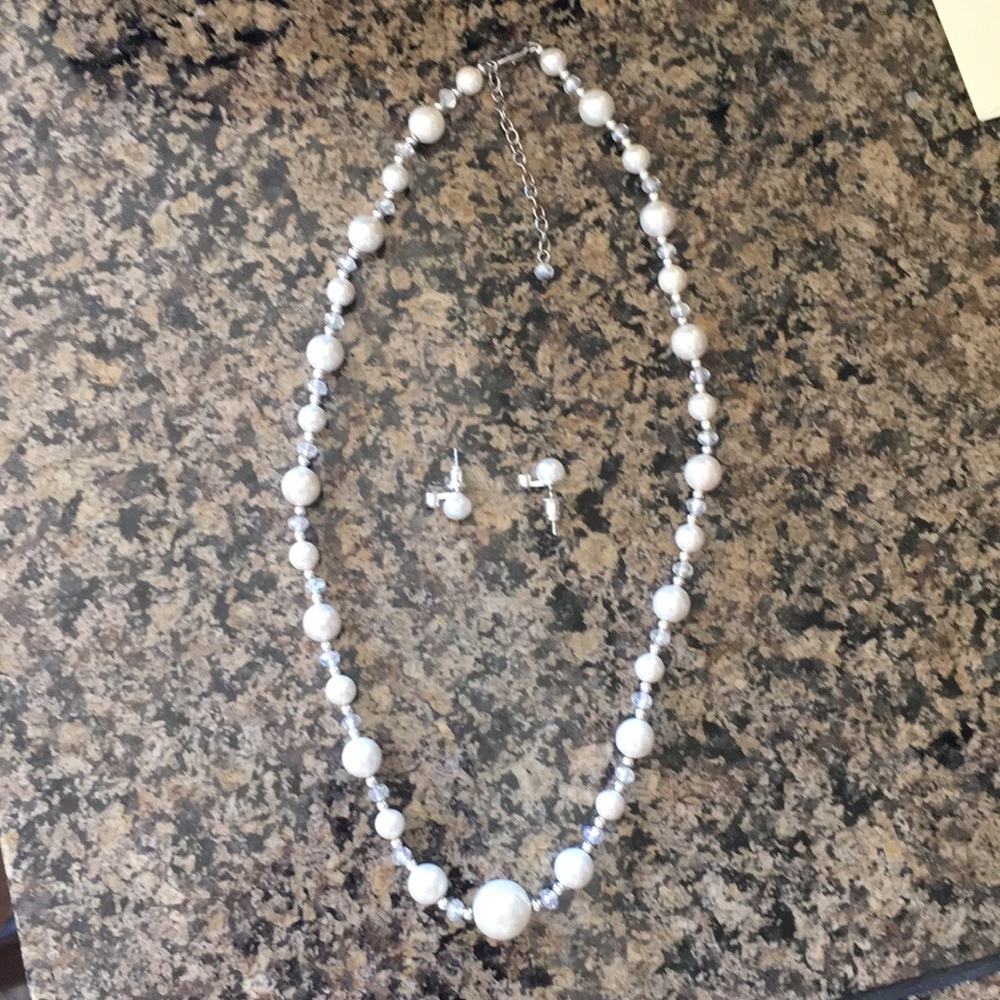 Pearl earrings and necklace with crystal accents.